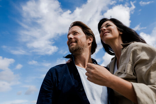Couple enjoying windy outdoor day expressing love and trust in nature