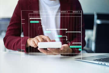 Hands typing on laptop with a digital Gantt chart overlay. Ideal for project planning, scheduling, productivity, workflow,