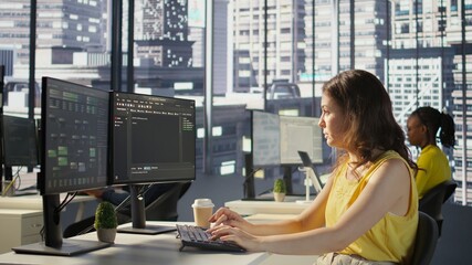 Manager in wheelchair passing by desk of employee testing machine learning company software to...