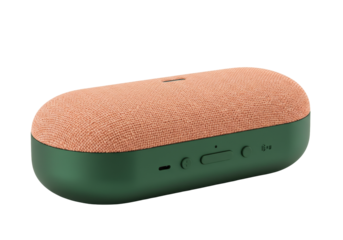 Isolated peach and green compact stereo speaker for music and podcasts on flat surface