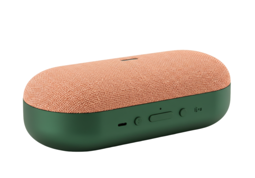 Isolated peach and green compact stereo speaker for music and podcasts on flat surface