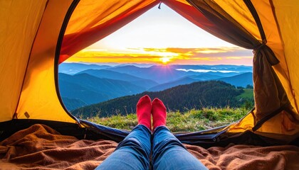 Sunrise mountain view seen from inside a tent, legs in red socks extended