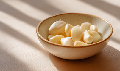 Fresh Peeled Garlic Cloves in a Ceramic Bowl with Natural Light Highlighting Clean Texture and Culinary Freshness. generative ai