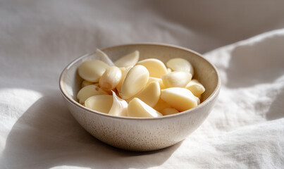 Fresh Peeled Garlic Cloves in a Ceramic Bowl with Natural Light Highlighting Clean Texture and Culinary Freshness. generative ai