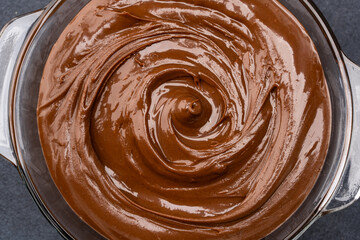 Cream chocolate in a bowl on a black background