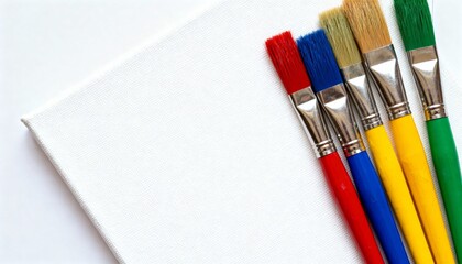 Vibrant art paintbrushes neatly arranged on a blank white canvas, ready for artistic creation.