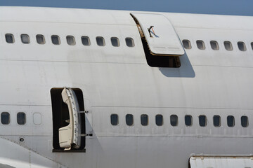 Old passenger airplane out of service and abandoned on the ground.