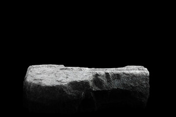 Stone podium on dark black background.