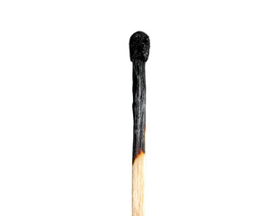 Close-up of a burnt matchstick against a solid black background