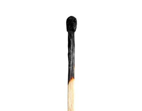 Close-up of a burnt matchstick against a solid black background