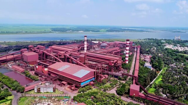Colorful iron ore transshipment. Aerial view of iron ore processing factory in India. Factory process iron ore into steel 4K.