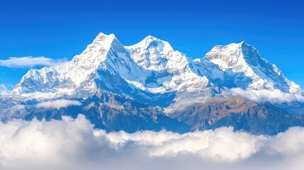 Obraz premium Majestic Snow-Capped Mountains Under Clear Blue Sky with Fluffy Clouds Below in Scenic Landscape