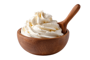 Close-up shot of whipped cream in a wooden bowl with a wooden spoon