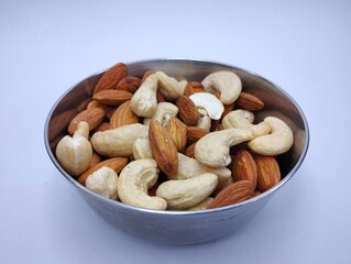 Bowl of Mixed Almonds and Cashews on a White Background