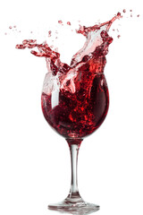 Splashing crimson drink in glass against black background