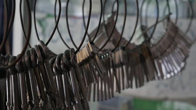 Multiple Duplicate Keys Hanging on Wire Rings at Locksmith Shop - Key Cutting and Duplication Service Business