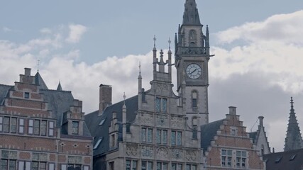 A close-up view of the central clock tower and intricate roofline of the former Post Office building (Postgebouw) in Ghent, Belgium.