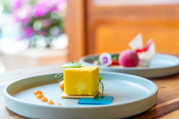 Elegant gourmet dessert on restaurant table with colorful presentation, featuring artistic plating and vibrant colors, perfect for fine dining, culinary arts, food styling themes.