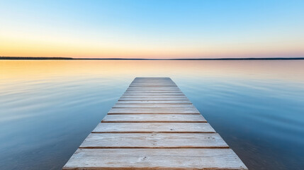 Fototapeta premium Calm lake with wooden dock at sunset, reflecting serene colors of twilight