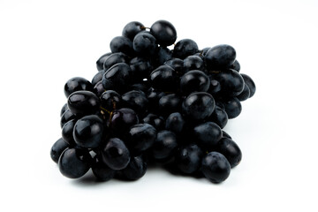 Fototapeta premium A bunch of black grapes on a white background. Fresh and juicy grapes.