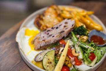 Delicious breakfast plate served with salad bread and fries
