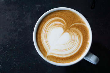 Top view of Latter art coffee on black table background.     
