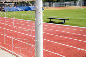 Soccer field and goal net with shallow depth of field for background