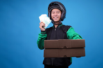 Smiling Asian Motorcycle Taxi Driver in Jacket and Helmet Holding Indonesian Rupiah Banknotes and...