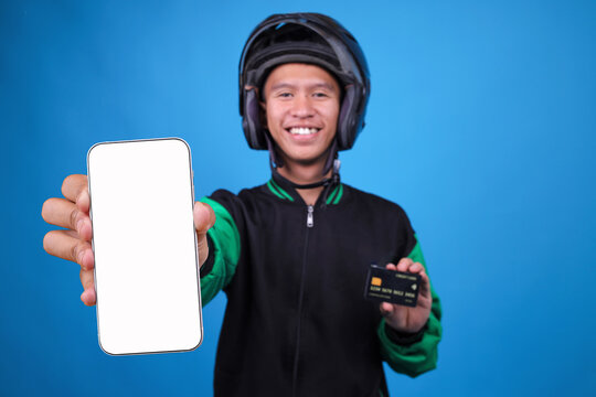 Smiling Asian Ojol Driver Holding White Screen Smartphone and Credit Card Promoting Digital Services