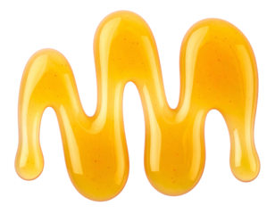 Close-up of golden, viscous liquid drizzled onto a black background in a squiggly line