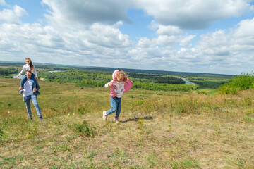 Father and children have fun, laugh and enjoy nature outdoors.