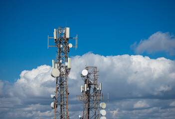 Telecommunication Towers with Antennas Under Blue Sky