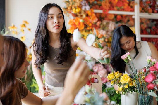 Women florists arranging flowers in workshop