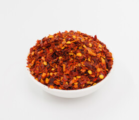 Crushed Red Chili Flakes In White Bowl, Fiery Spice For Cooking And Garnish