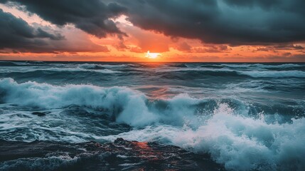 Fototapeta premium Dramatic sunrise over a stormy sea with crashing waves.