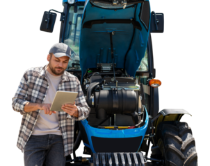 Agricultural machinery mechanic using a computer tablet near the tractor.