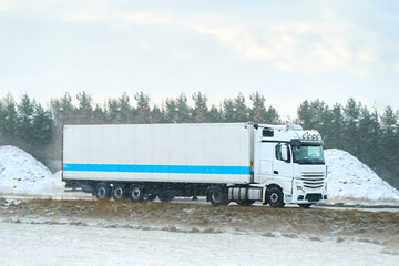 Truck driving in frozen rural landscape