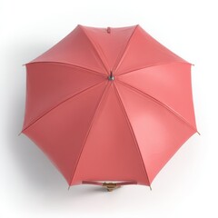 Overhead view of a closed coral umbrella on a white background studio shot for weather protection and fashion accessory