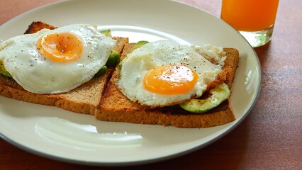 Healthy breakfast with fried egg on avocado toast surrounded by fresh ingredients and daylight Breakfast reflects mindful lifestyle natural taste balance Nourishing breakfast promotes calm energy