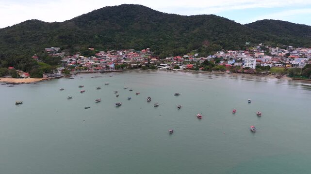 Amazing aerial view of calm fishing boats anchored in small bay of Praia do Trapiche near Penha city, Santa Catarina, Brazil.