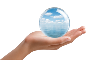 Female hand Holding a Crystal Ball Reflecting Ocean and Sky