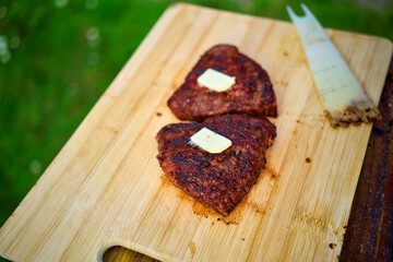 Sizzling barbecue steak on rustic wooden grill