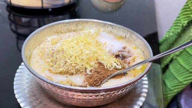 Traditional Persian haleem served in copper metal bowl and garnished with fried onions coriander healthy halal dish thick lentil soup Islamic cuisine Ramadan Iftar dinner Tehran Iran gastronomy