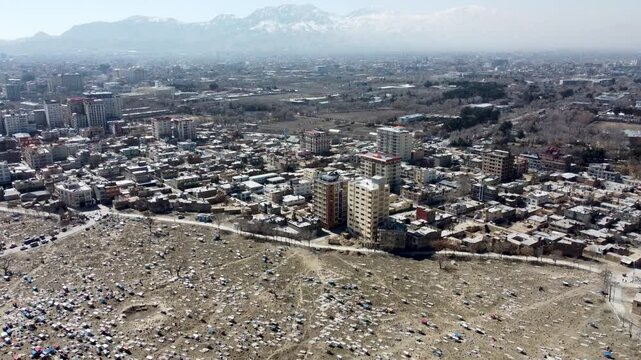War struck Kabul, Afghanistan. Drone Shot of Sakhi Shrine Blue Mosque, Cemetery and Hillside Homes. Deaths of war