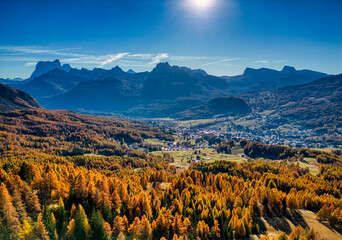 Fototapeta premium Autumn in the Dolomites. The woods and mountains above Cortina d'Ampezzo seen from above.