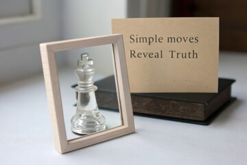 Transparent glass chess king framed by wood with a truth message