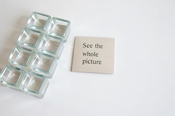 Transparent glass cubes aligned beside a conceptual message card