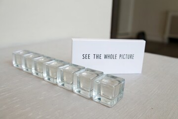 Transparent glass cubes aligned in a neat row with a message card