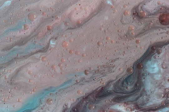 Soft marbling pattern features muted pink, taupe, and blue fluid swirls with small bubbles. Organic wavy lines and gentle transitions create a calm atmosphere. The whole frame is filled