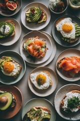 Overhead flat lay of gourmet toasts with avocado egg salmon grapefruit at brunch table setting
